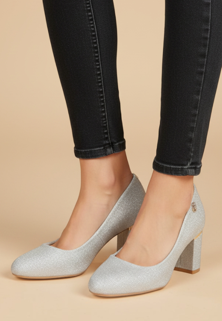 Falio silver glitter block heel pumps with almond toe and metallic heel detail worn with black skinny jeans