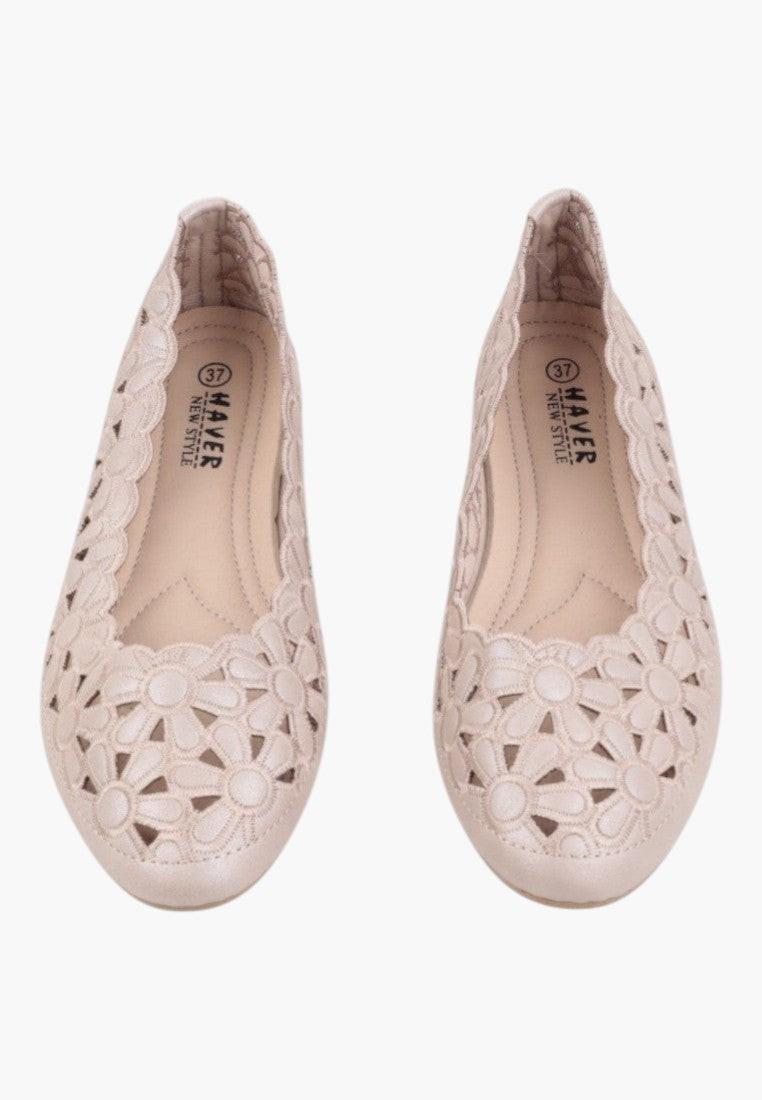 Back view of beige ballet flats showcasing the cut-out design.