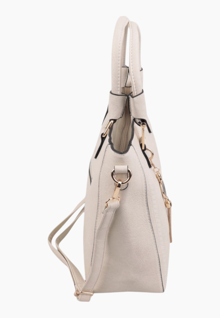 Side view of a cream handbag with shoulder strap and gold hardware.