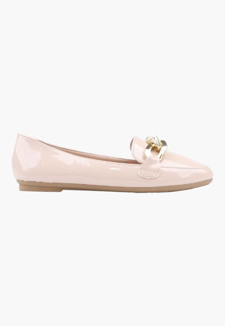 Side view of beige ballet flats with bow detail on a white background