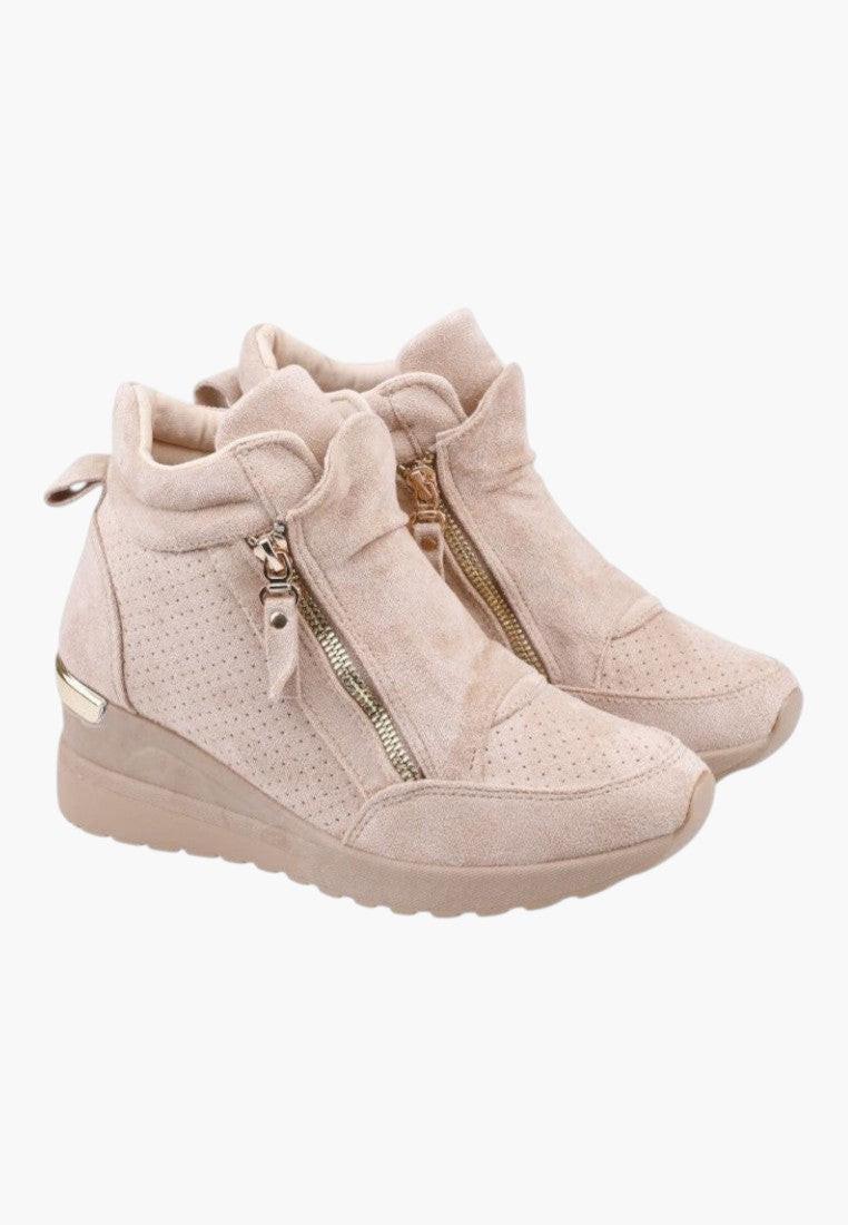 Side view of beige ankle boots with zipper closure and ruffled detail on a white background