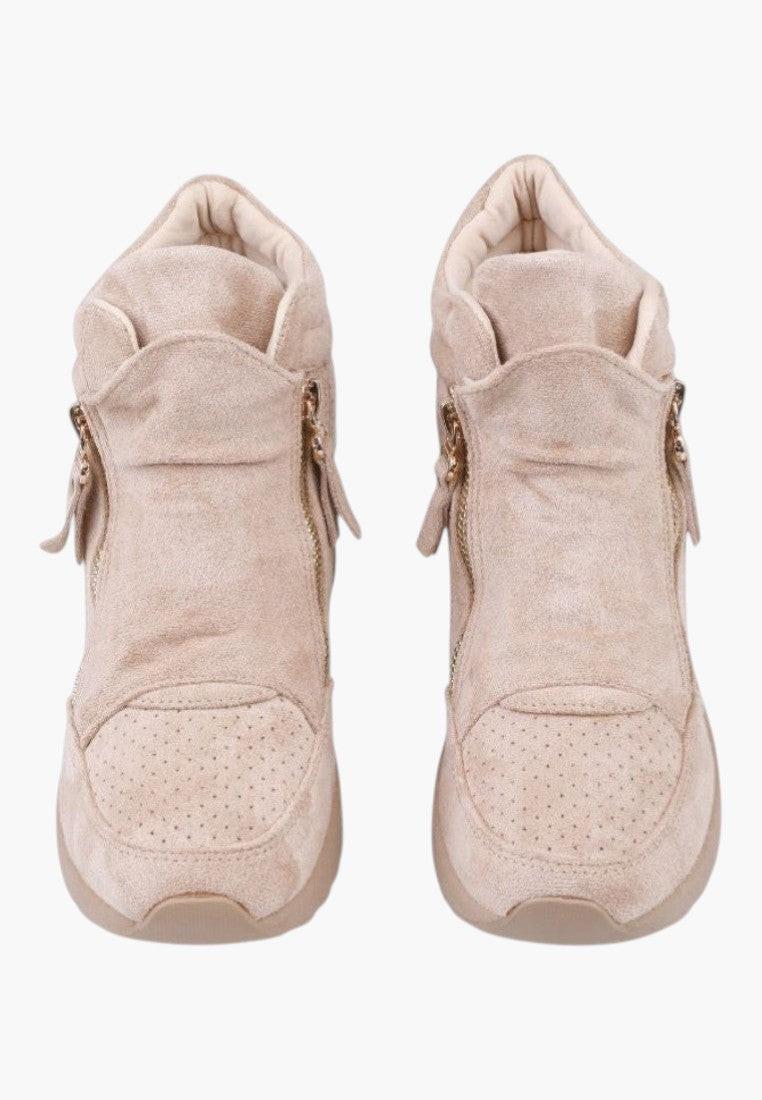 Lifestyle shot of beige wedge sneakers showcasing stylish design on a white background