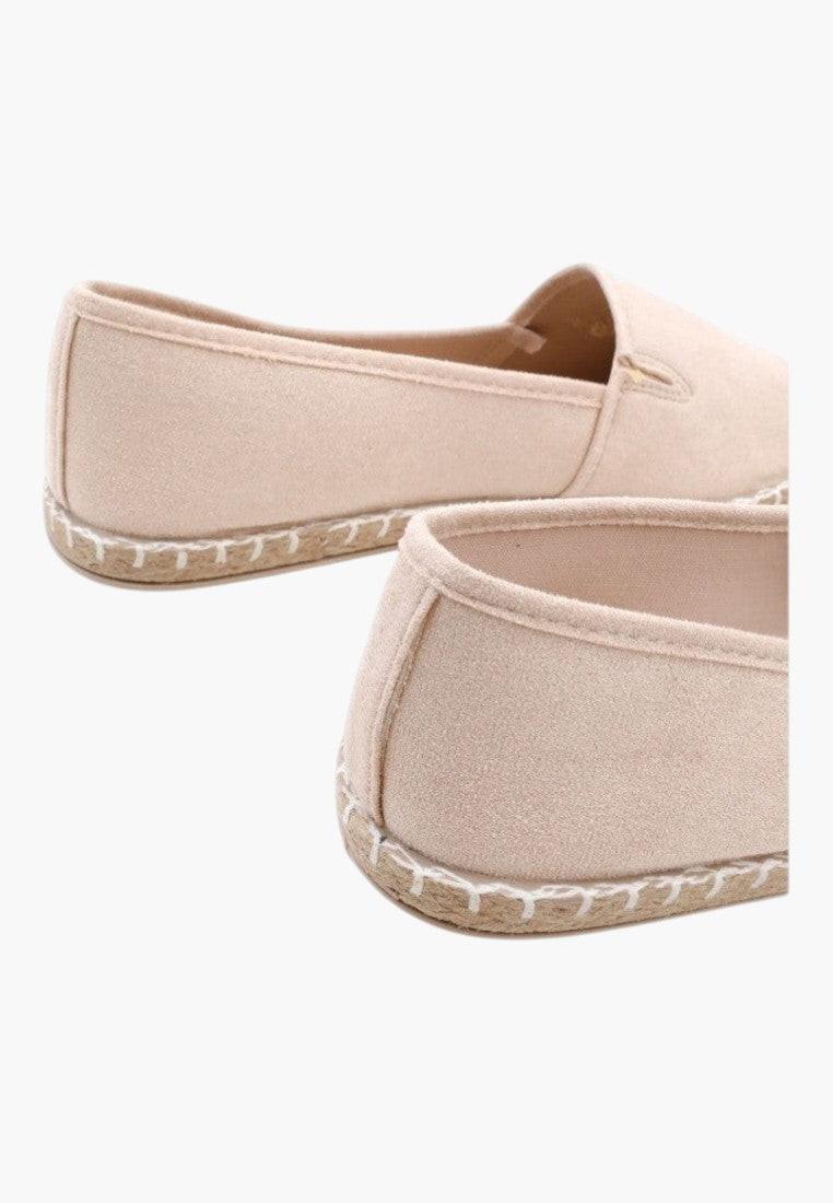 Side view of beige espadrilles with a minimalist style and low profile