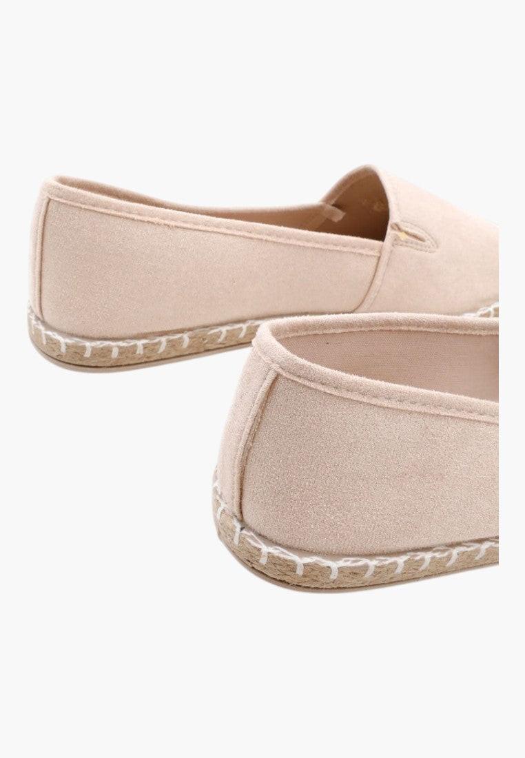 Side view of beige slip-on espadrilles with sleek profile and no laces