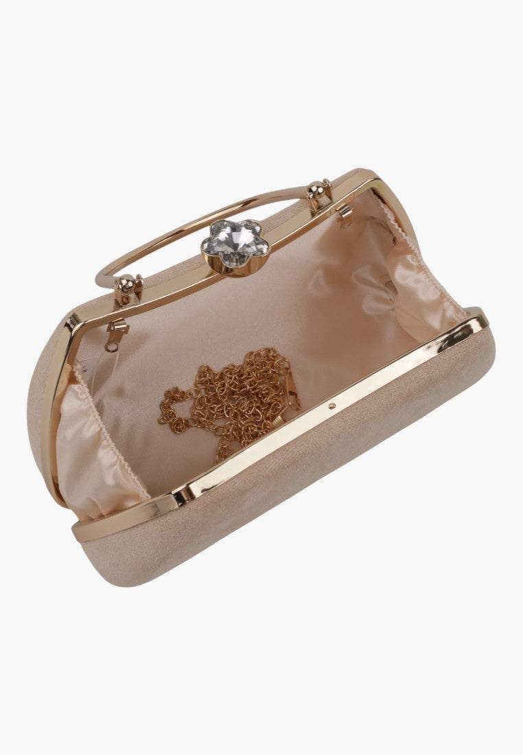 Detail view of a beige handbag with a metal clasp and interior pattern on a white background