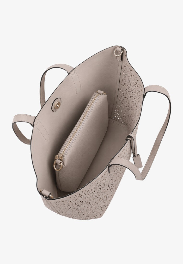 Detail close-up of the interior of a beige handbag with two compartments and a snap closure on a white background.