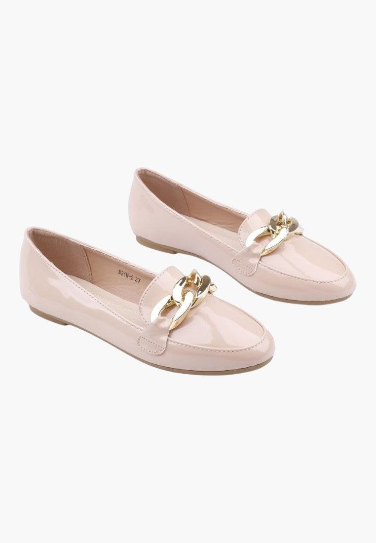 Front view of beige loafers with gold hardware on a white background