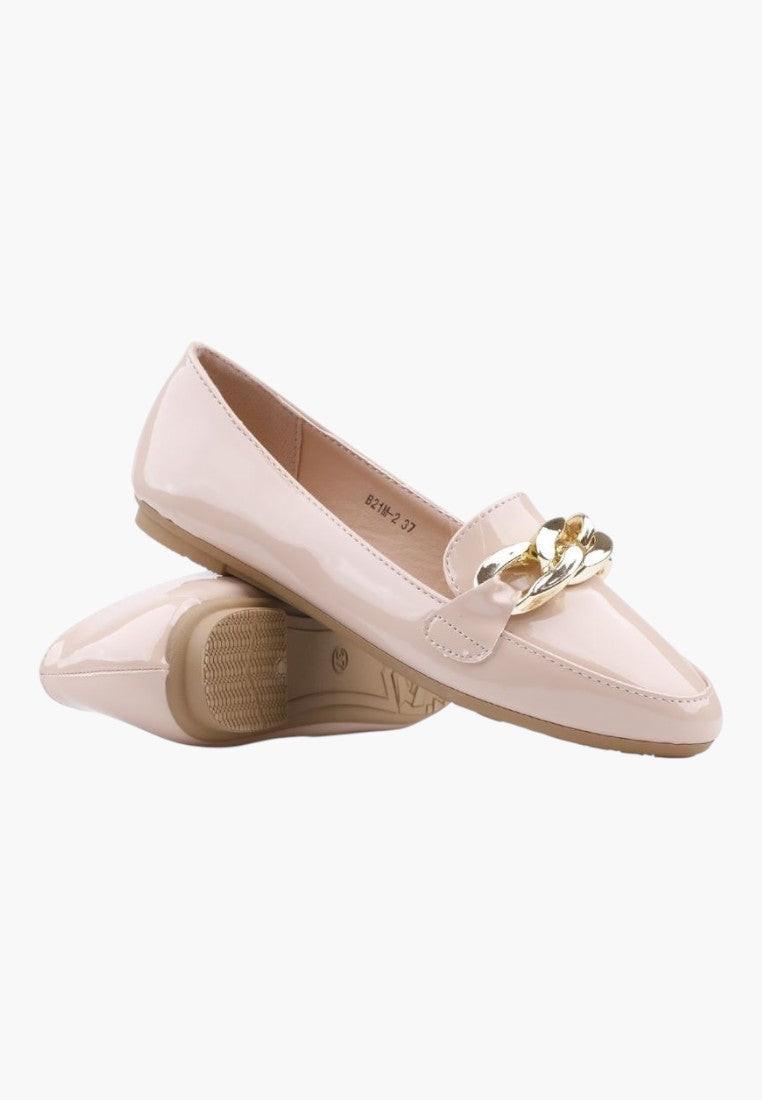 Side view of beige loafers showcasing gold hardware on a white background