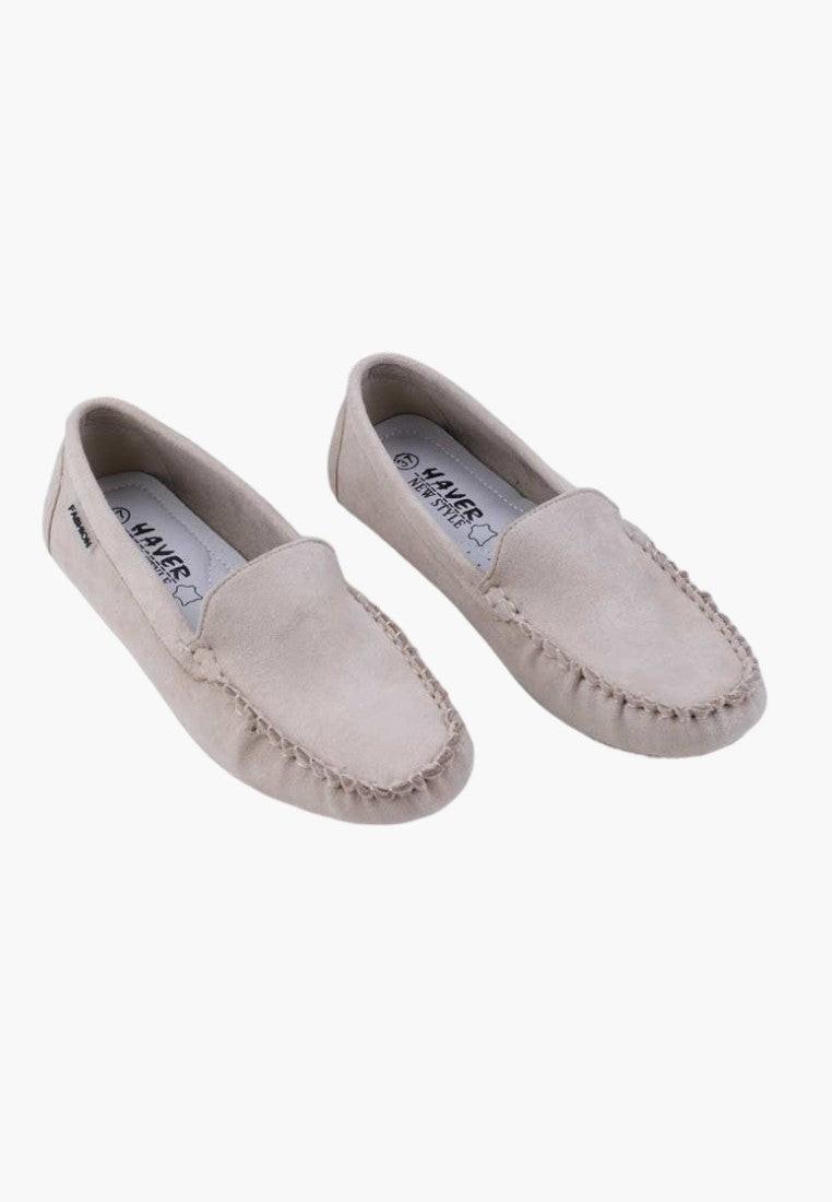 Front view of beige slip-on shoes with rounded toe on a white background