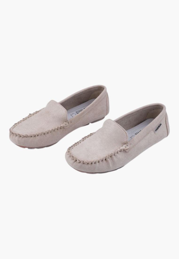 Front view of beige slip-on shoes with rounded toe on a white background