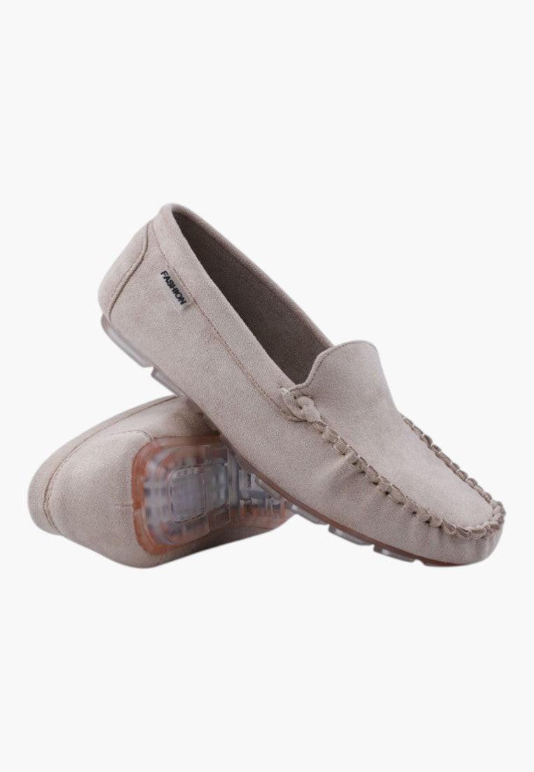 Front view of beige slip-on shoes with rounded toe on a white background