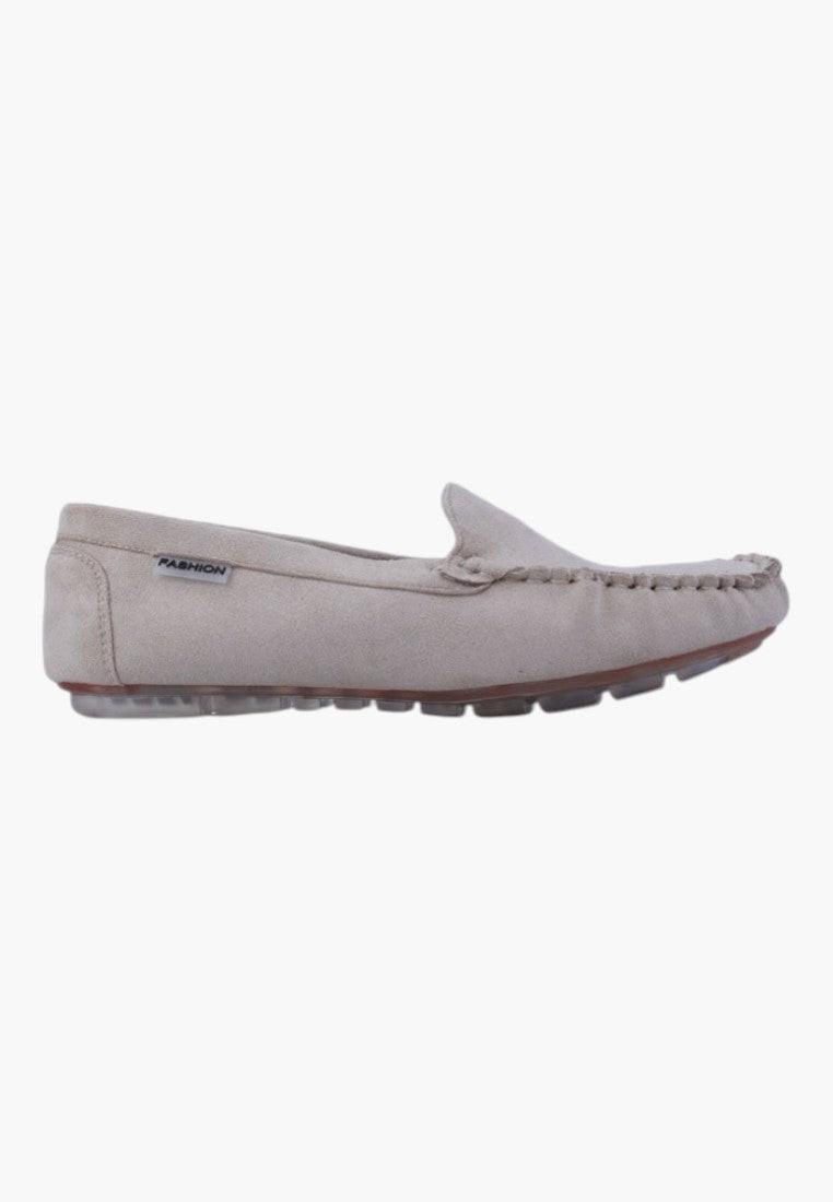 Side view of beige slip-on shoes with textured sole on a white background