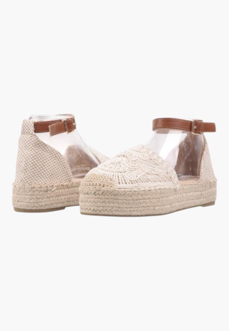 Side view of beige platform sandals with ankle strap.