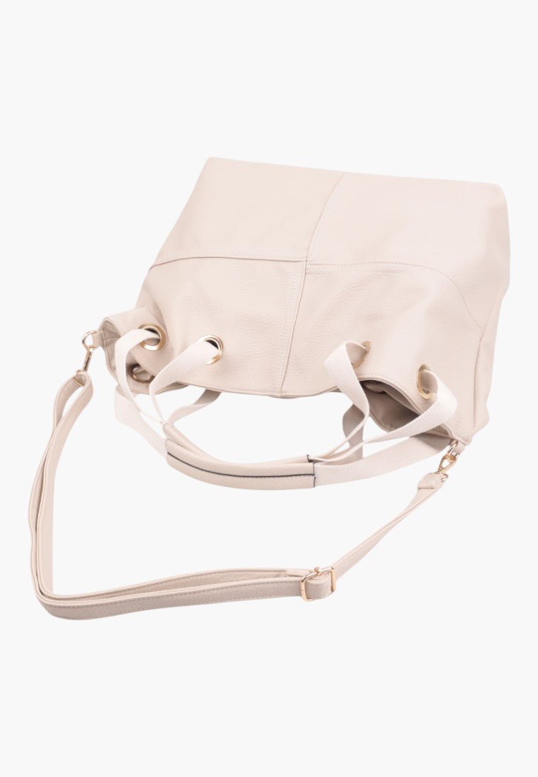 Front view of a beige handbag with a structured shape.