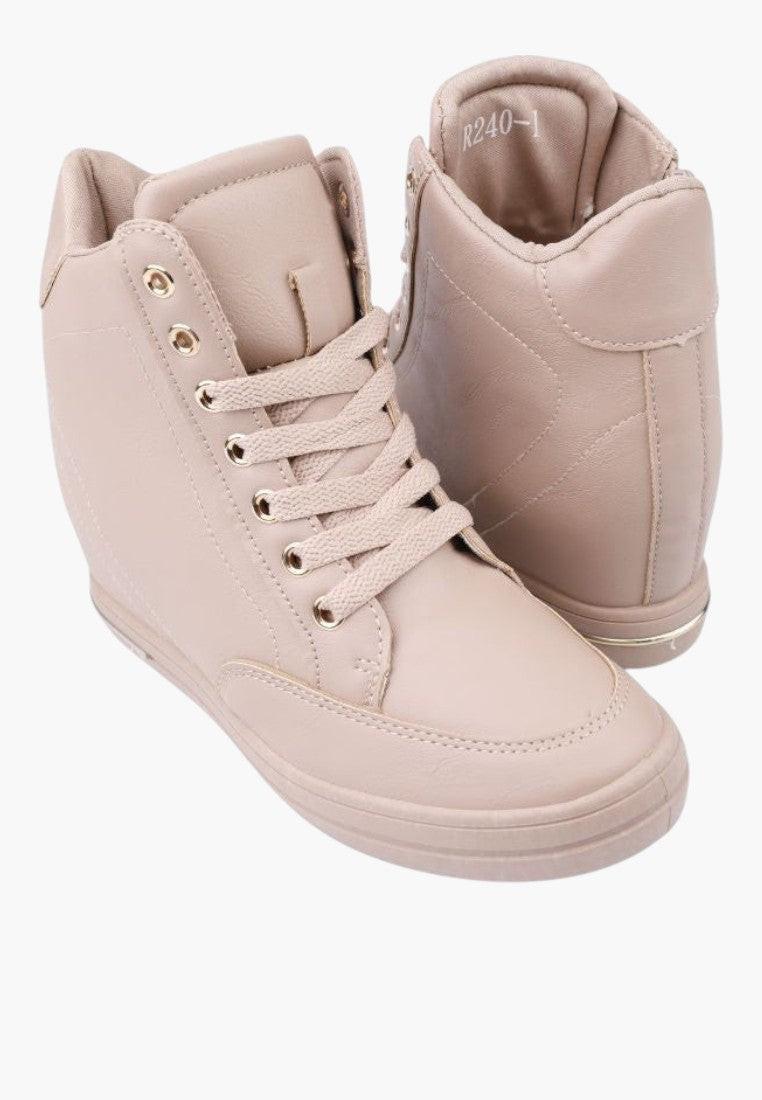 Zbliżenie na beżowe sneakersy damskie z miękkiego materiału.