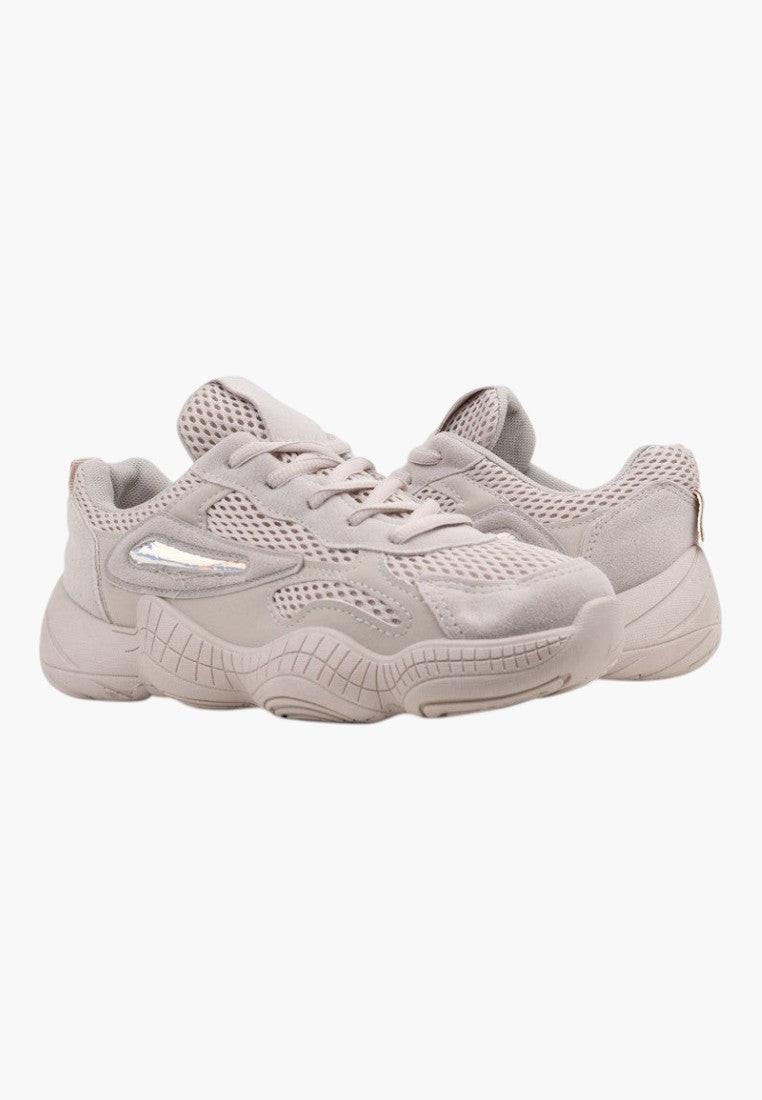 Back view of beige sneakers featuring a heel tab and soft material on a white background