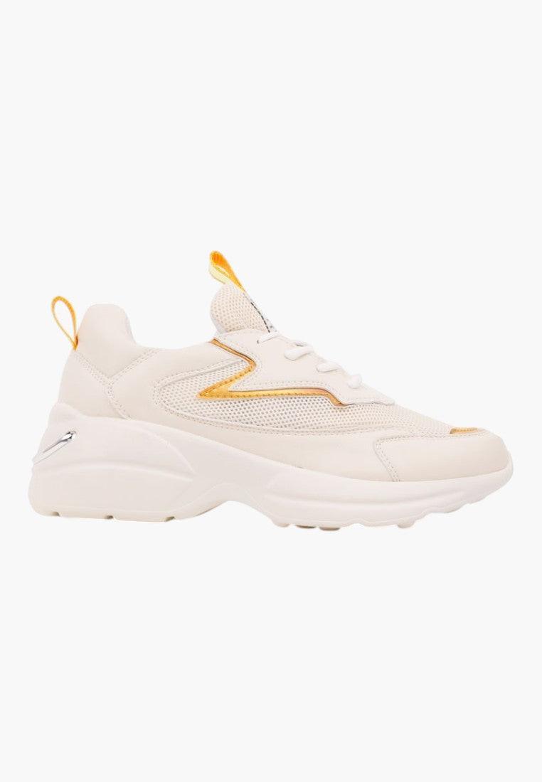 Lifestyle shot of beige sneakers showcasing a comfortable fit on a white background