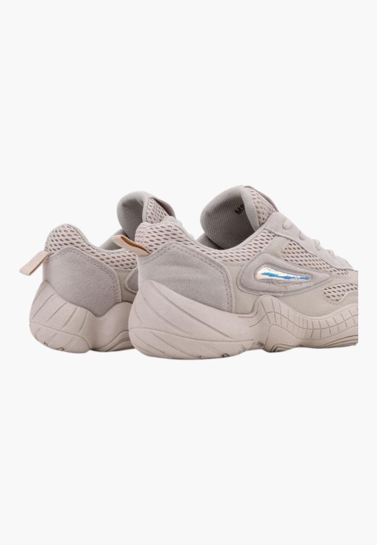 Lifestyle shot of beige sneakers highlighting stylish design and comfortable fit