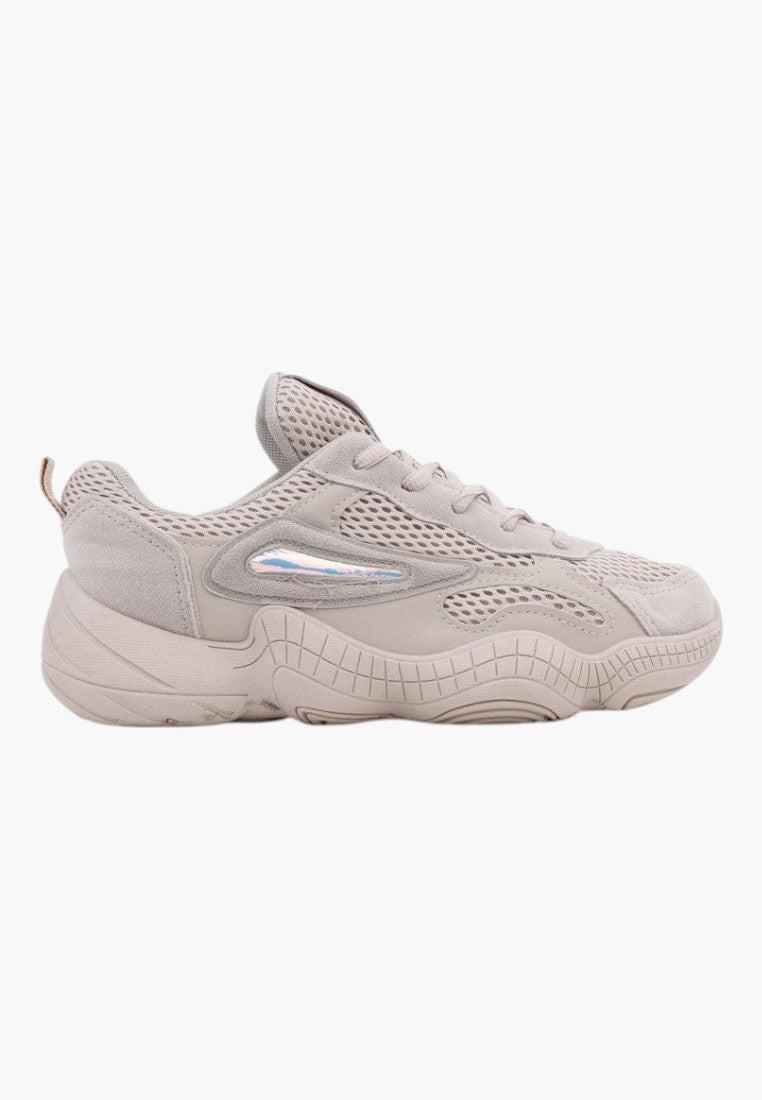 Side view of beige sneakers with smooth texture and logo detail on a white background