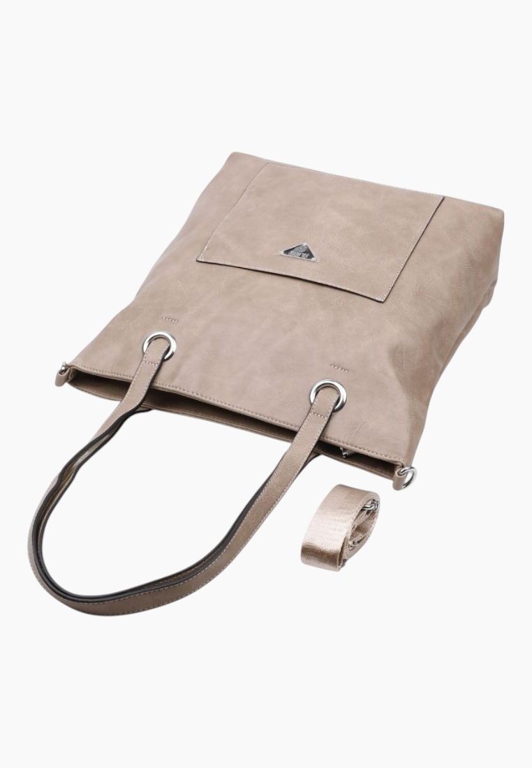 Close-up of the beige tote bag's front pocket and double handles.