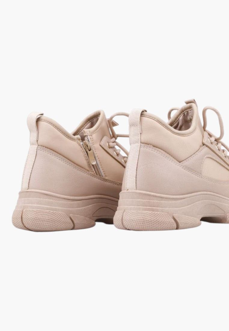 Back view of beige sneakers showing the textured material and high-top design.