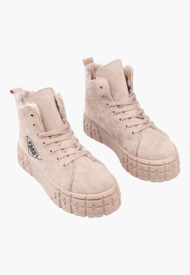 Front view of beige ankle boots with a textured fabric on a white background