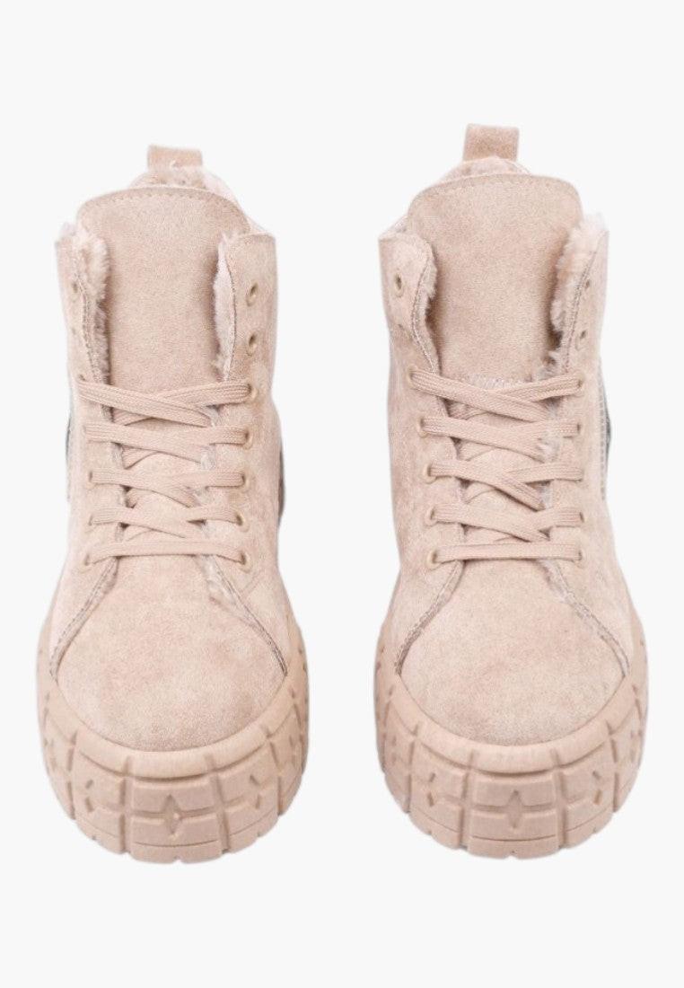 Side view of beige ankle boots showcasing a thick sole and high-top design
