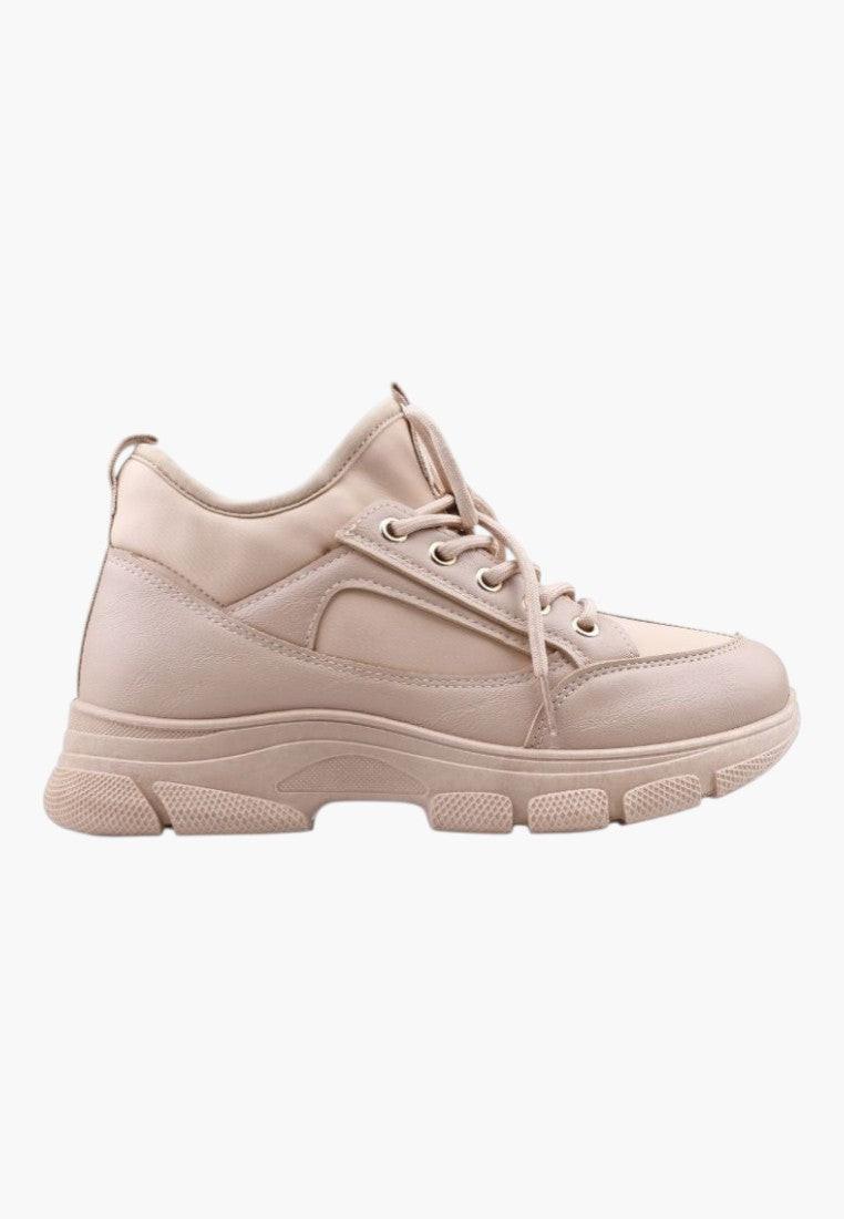 Side view of beige sneakers showcasing the chunky sole and smooth finish.