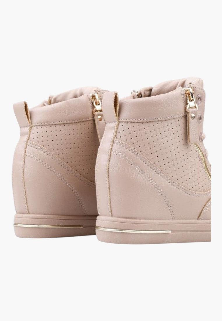 Back view of beige wedge sneakers showcasing zipper detail and textured surface