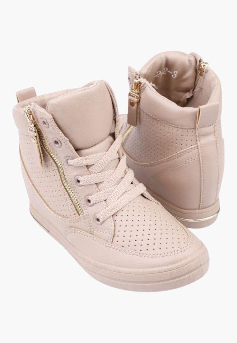 Close-up detail of beige wedge sneakers with lace-up design and folded collar
