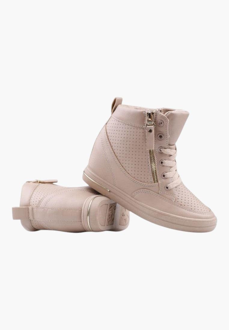 Side view of beige wedge sneakers featuring zipper detail on a white background