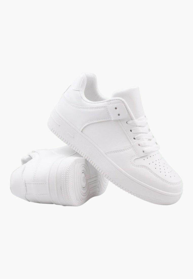 Side view of white sneakers featuring a chunky sole and smooth finish.