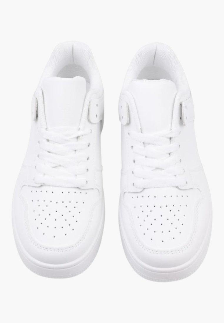 Side view of white sneakers showcasing a sleek design and textured sole.