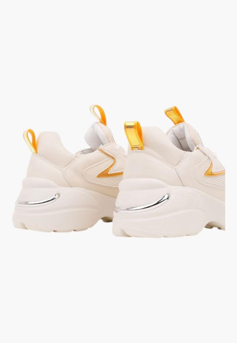 Front view of white sneakers with yellow accents on a white background
