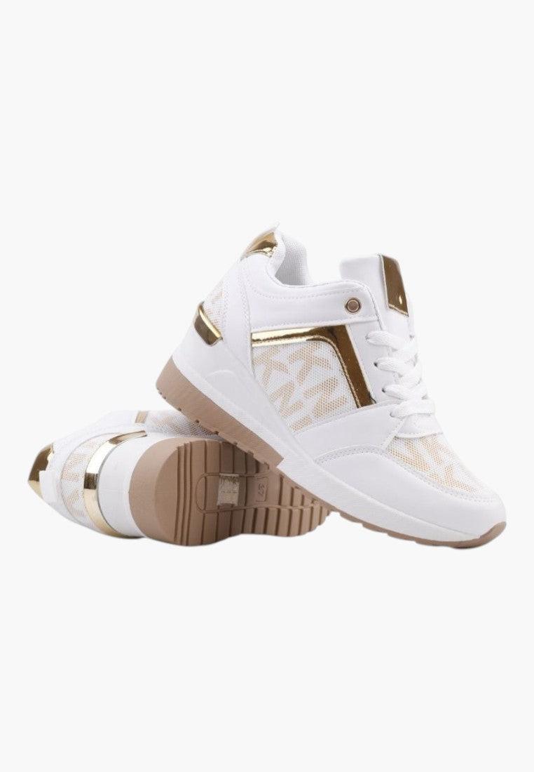 Lifestyle shot of white and gold sneakers with textured sole