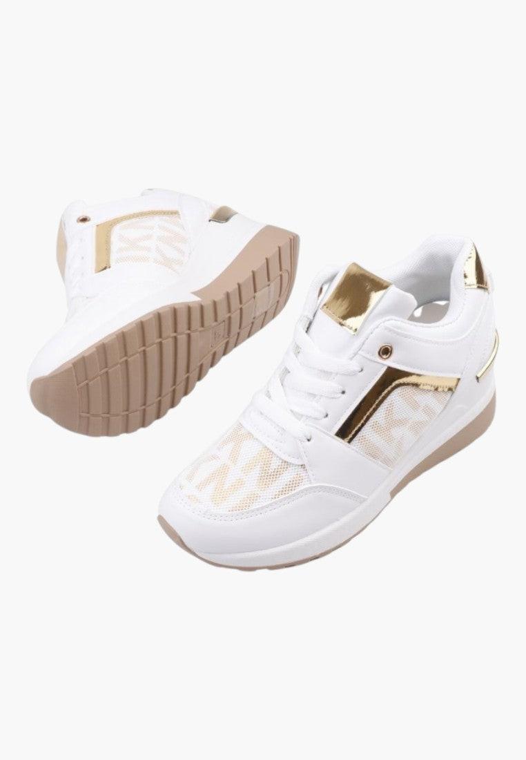 Side view of white and gold sneakers with decorative details