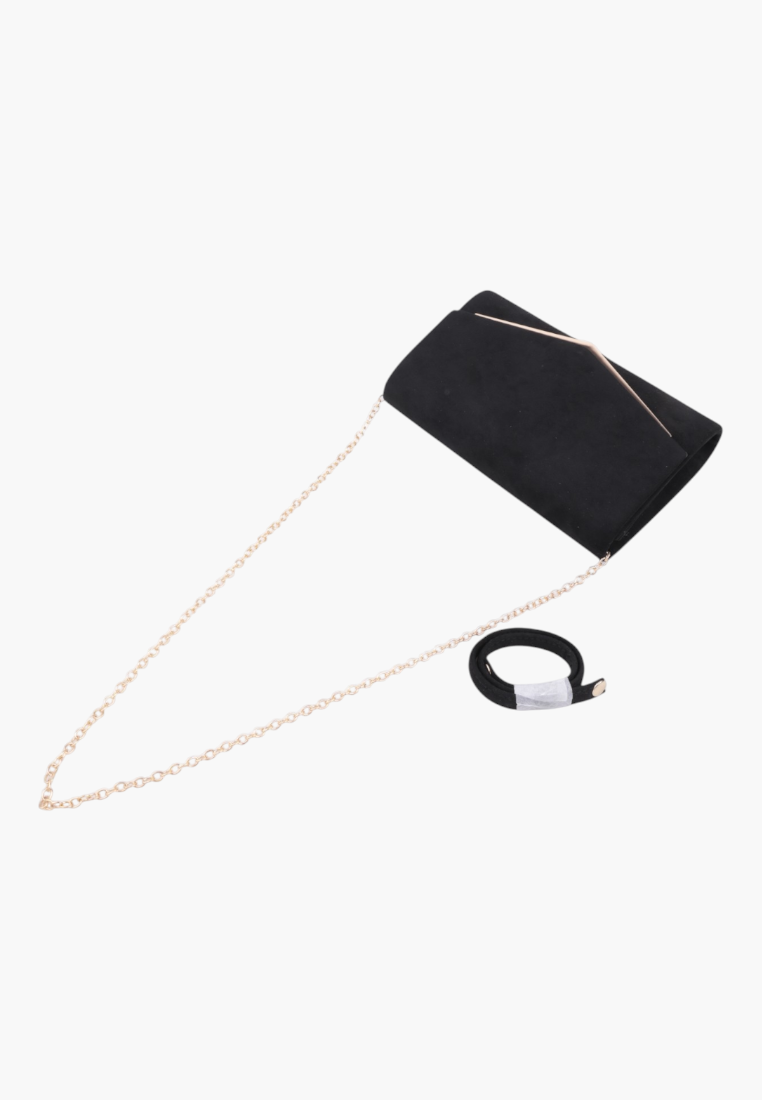 Side view of the black faux leather envelope clutch with a gold chain strap.