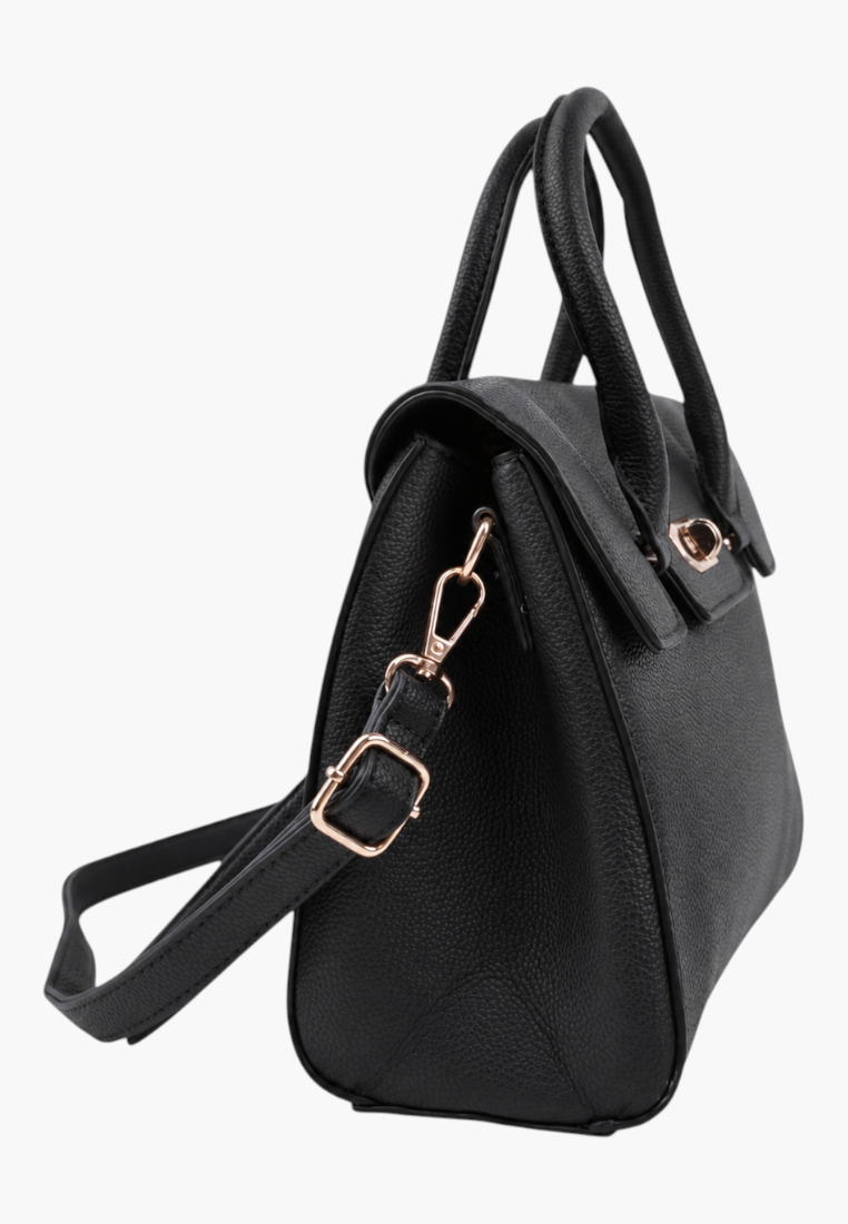 Detail close-up of a black handbag showcasing its side view and gold hardware on a white background.