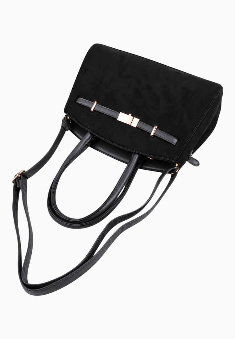 Detail close-up of the black handbag showing soft material from the side.