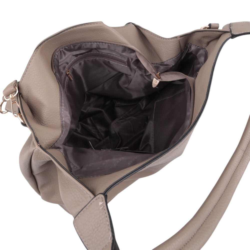 Detail view of the interior of the black handbag with multiple compartments on a different background