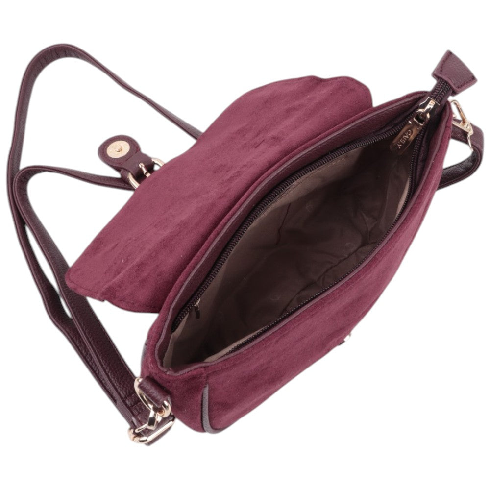 Detail view of the burgundy handbag interior with an open design and zipper pocket.