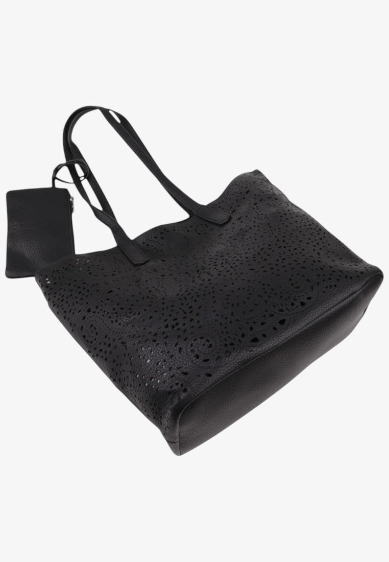 Side view of a simple black tote bag on a white background.