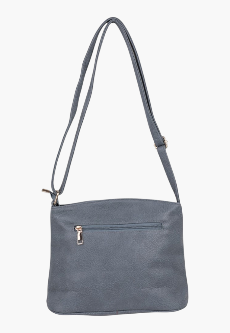 Close-up detail of a blue handbag showcasing zipper closure and gold hardware on a white background.