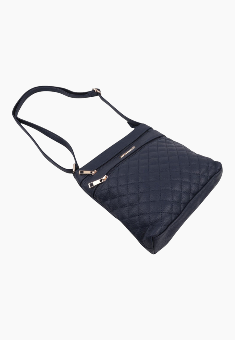 Side view of the navy quilted handbag with a shoulder strap.