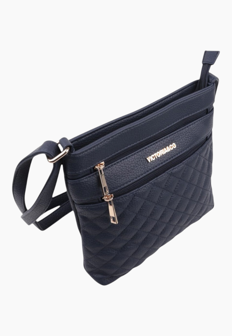 Side view of the navy handbag showcasing a zipper pocket and shoulder strap.