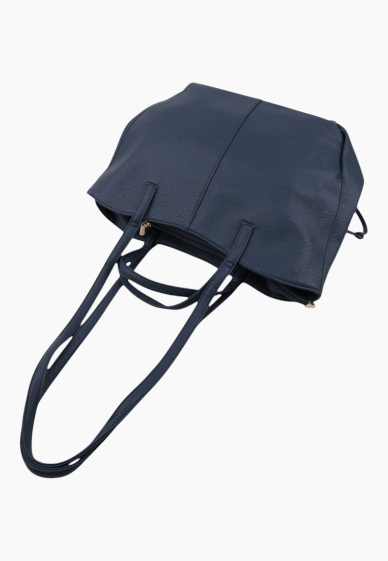 Detail view of a navy tote bag highlighting the side with two handles.