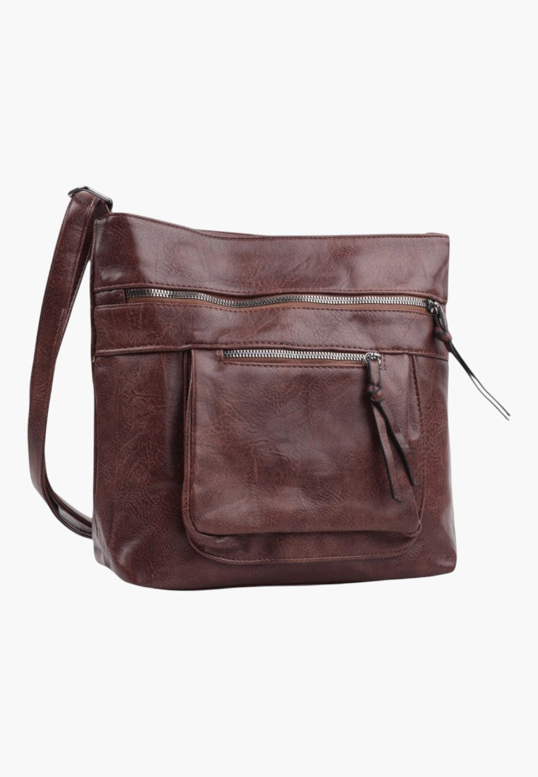 Detail of brown faux leather crossbody bag showing zipper closure and front pocket.