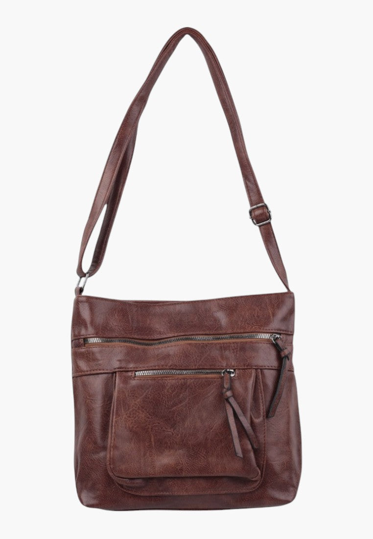 Front view of brown faux leather crossbody bag with adjustable strap and front pocket.