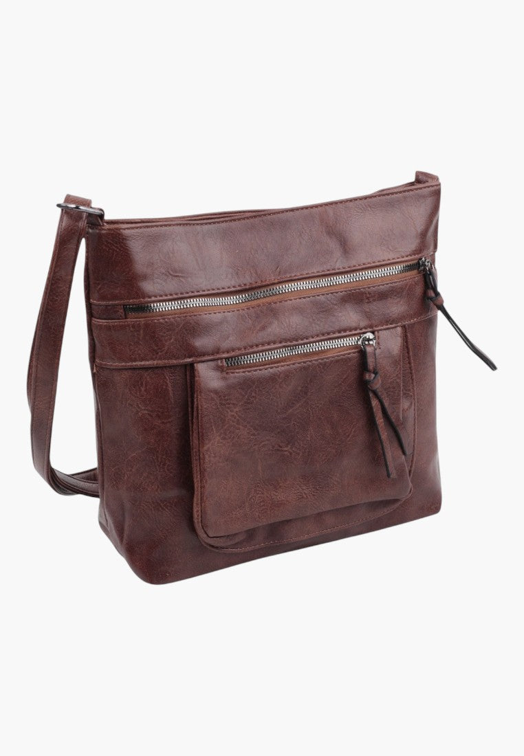 Front view of brown faux leather crossbody bag with zipper closure and front pockets.