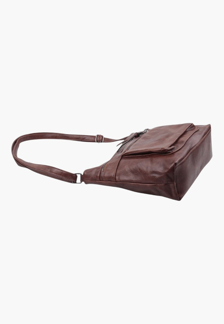 Other angle of brown faux leather crossbody bag with adjustable strap and multiple zippered pockets.